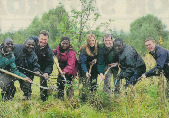 Dale With Ugandan Rangers Helping Plant A Tree